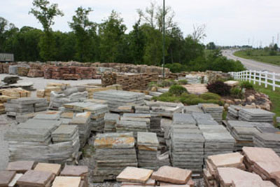 Stacks of flagstone and natural landscaping stone at the yard