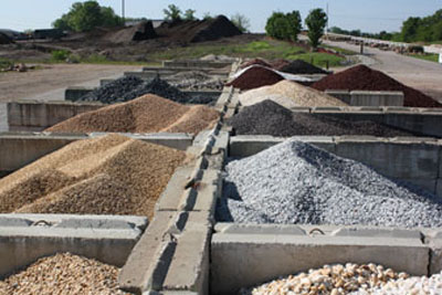 Concrete bins holding gravel, sand, and stone in a range of sizes